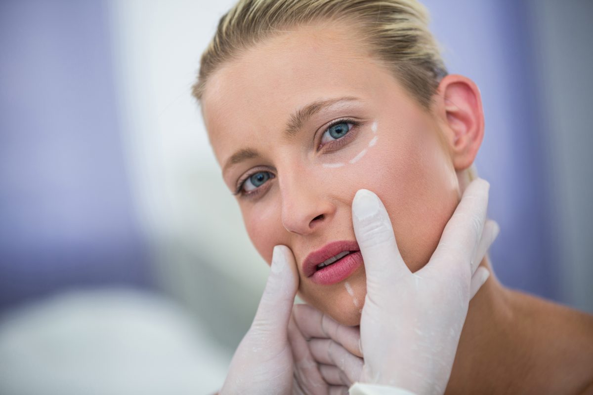 doctor-examining-female-patients-face-cosmetic-treatment-1200x800.jpg